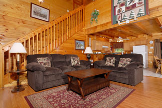 Pigeon Forge Four Bedroom Cabin that features comfortable living room furniture with hard wood floors and a wood interior.